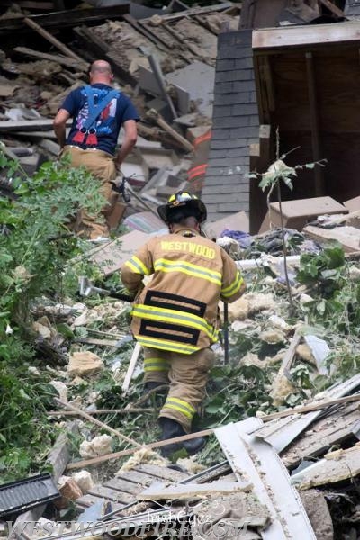 Battalion Chief Sly and Firefighter/EMT Bengough climb to the top of the debris pile